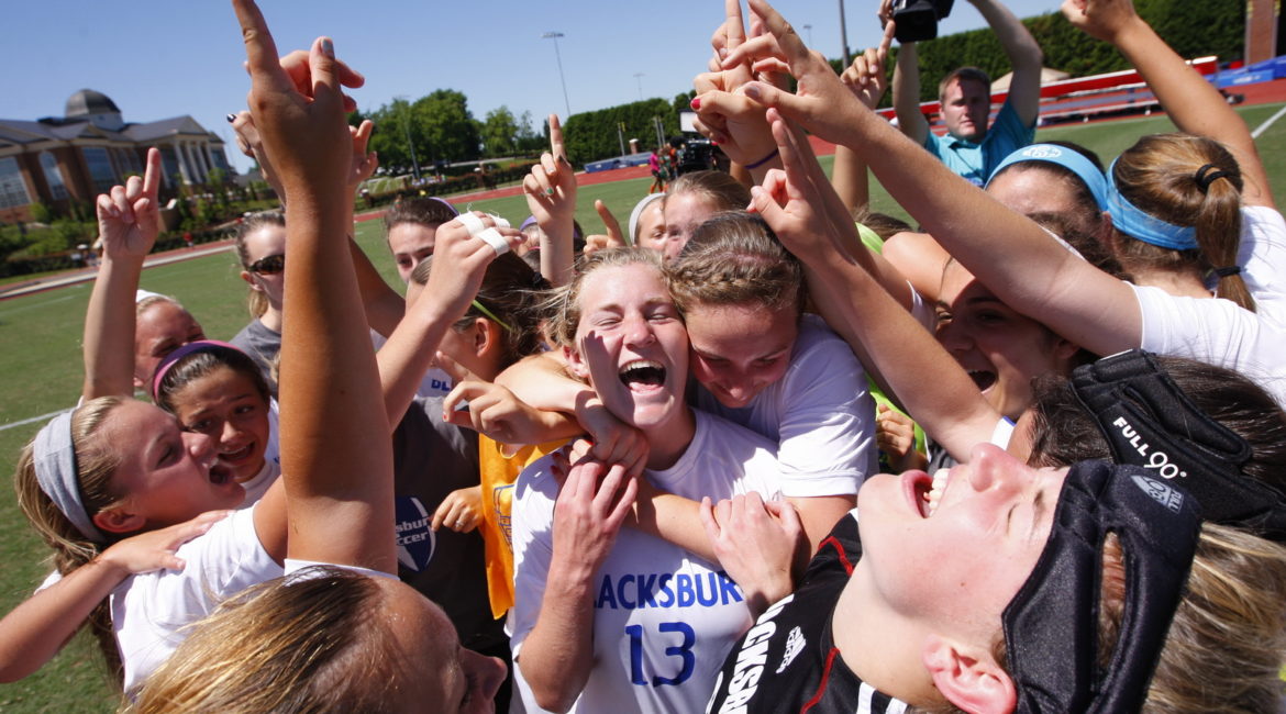 After defeating Kettle Run 1-0, Jane Everett (center) and teammates celebrate Blacksburg's first ever girls soccer state championship.
